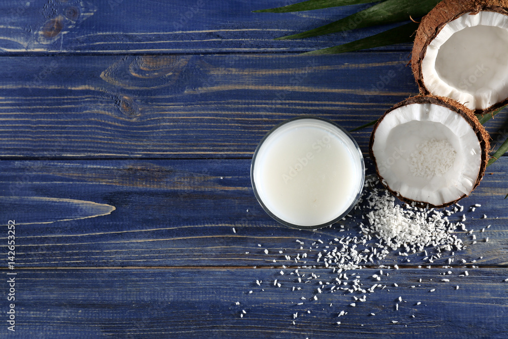 Composition with fresh coconut milk on wooden background