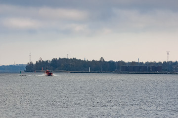 Sticker - Red pilot ship moving at speed to Baltic sea. Riga, Europe