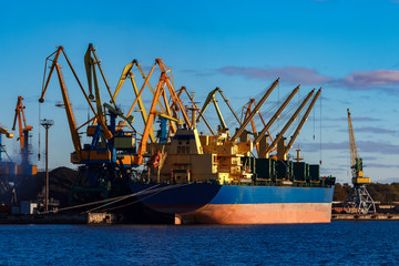 Blue cargo ship loading in the port of Riga, Europe