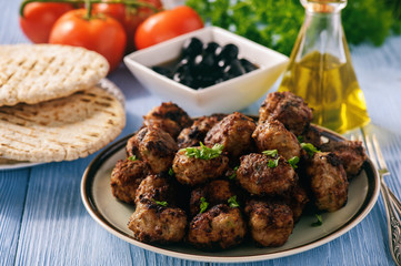 Wall Mural - Greek meatballs (keftedes) with pita bread and tzatziki dip.
