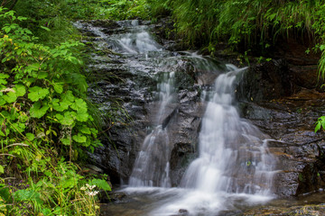  Waterfall on mountain river in Carpathian Mountains , Romania