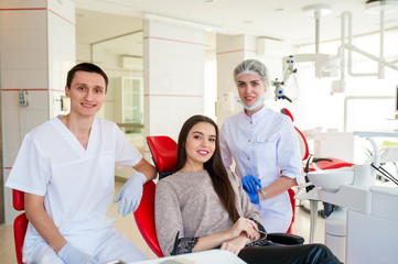 Wall Mural - Portrait of dentists and happy girl.