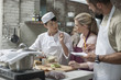 © Westend61 - Participants and female chef cooking in cooking class