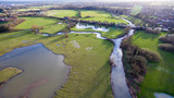 Fototapeta Las - Aerial view of a lake and river in the countryside