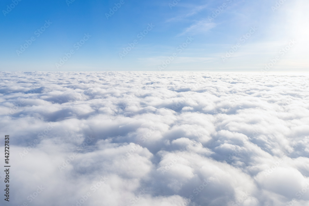 View from airplane window above the clouds - obrazy, fototapety, plakaty 