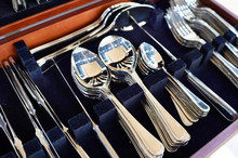 Cutlery Forks, Spoons And Knives On Dark Blue Velvet