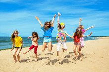  Happy Active Children Jumping On The Beach