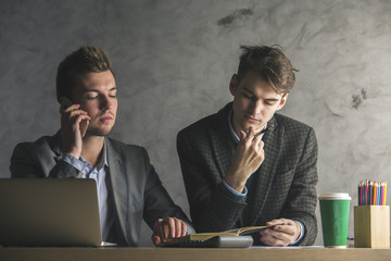 Wall Mural - Handsome businessmen on phone doing paperwork