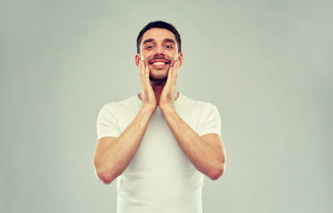 Poster - happy young man applying aftershave to face