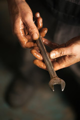 Wall Mural - Mechanic. Dirty hands holding wrench.