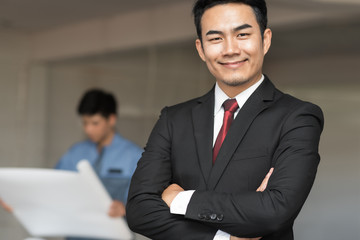 Portrait of handsome confident young businessman smiling