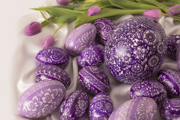  purple eastern egg on white cloth with purple tulip