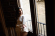 © javiindy - Woman in pyjama and white panties posing near a window