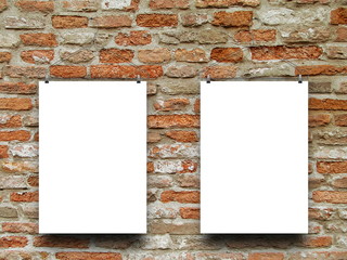 Two blank frames against orange weathered brick wall background