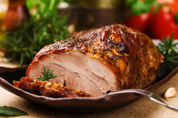 Roast pork with herbs and vegetables.