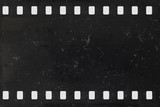 Fototapeta Las - Strip of old negative celluloid film with dust and scratches