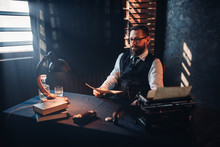 Bearded Man In Glasses Reads Handwritten Text