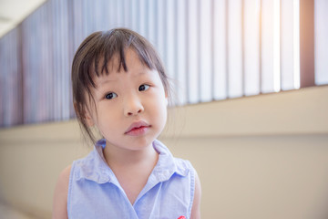 Wall Mural - Little asian girl thinking about something