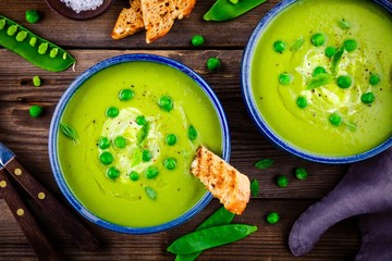 Canvas Print - Green pea soup on wooden rustic background