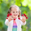 © famveldman - Child picking and eating raspberry in summer