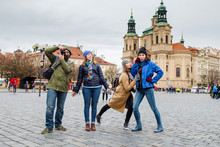 Group Of Happy Smiling Multiracial Friends Walking And Have Fun In The Old City Of Prague. Travel With Friends Concept