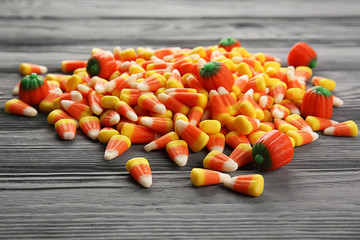 Sticker - Tasty Halloween candies on wooden background