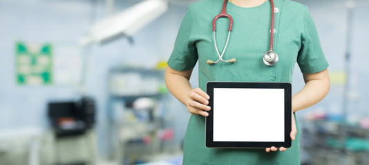 Doctor working with tablet computer with operating room,Young professional woman doctor medical students or surgeon using digital tablet showing result research something holding blank digital tablet