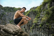 © theartofphoto - Half body shot of a handsome young man standing on a beach in Phuket Island, Thailand, shirtless wearing boxer shorts, showing muscular fit body, looking away to a side