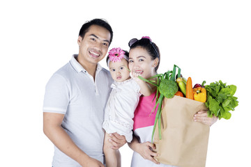 Sticker - Happy family holds vegetables in studio