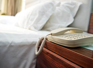 Wall Mural - Phone on a table near a bed.