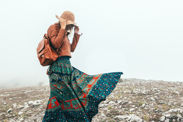 Poster - Woman in boho clothing traveling in fog weather