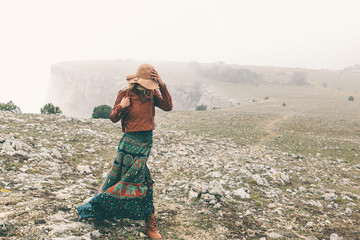 Wall Mural - woman in boho clothing traveling in fog weather