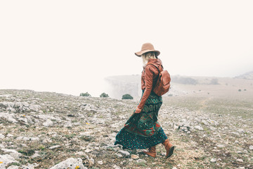 Poster - Woman in boho clothing traveling in fog weather