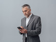 © stokkete - Businessman texting with his smartphone
