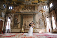 Bride And Groom In A Room With Frescoes In Venice