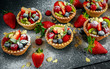 Berry tartlets with blueberries, raspberries, kiwi, strawberries, almond flakes in icing sugar.