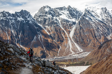 Trekker goes down fron Larke La pass on Manaslu circuit trek in Nepal