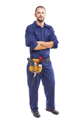 Wall Mural - Portrait of a young worker standing with arms crossed on white background