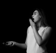 © MFcreated - Young pretty girl uses flashlight Grayscale