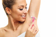 © Kalim - Adult woman shaving armpit with pink shaver isolated on white background