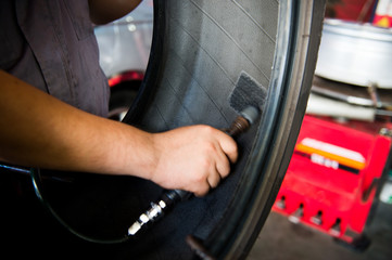 Mechanic making a patch on the rubber.