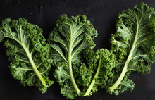 Fresh Green Organic Kale Leaves On Dark Background