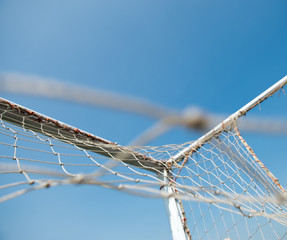 Wall Mural - soccer goal against blue sky background.