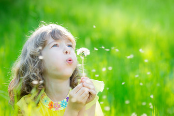 Sticker - Happy child blowing dandelion flower outdoors