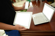 © xy - phone and tablet pc in hand and laptop on the table.