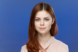 Fototapeta Młodzieżowe - beautiful face, red hair, confident look of a woman