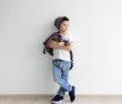 © Africa Studio - Cute stylish boy near light wall