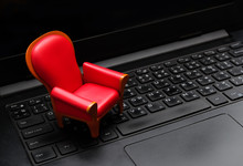 Close Up Mini Red Seat On Black Laptop Keyboard,Live Streaming Video Watching Concept,vip Seat