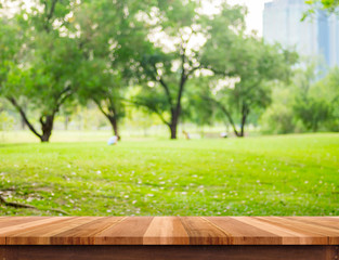 Aufkleber - Empty brown plank wood table top with blur green tree in park with bokeh background, Template mock up for montage or display of product