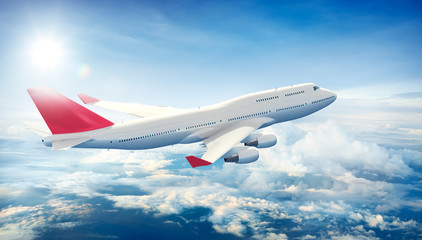 Wall Mural - airplane flying above clouds